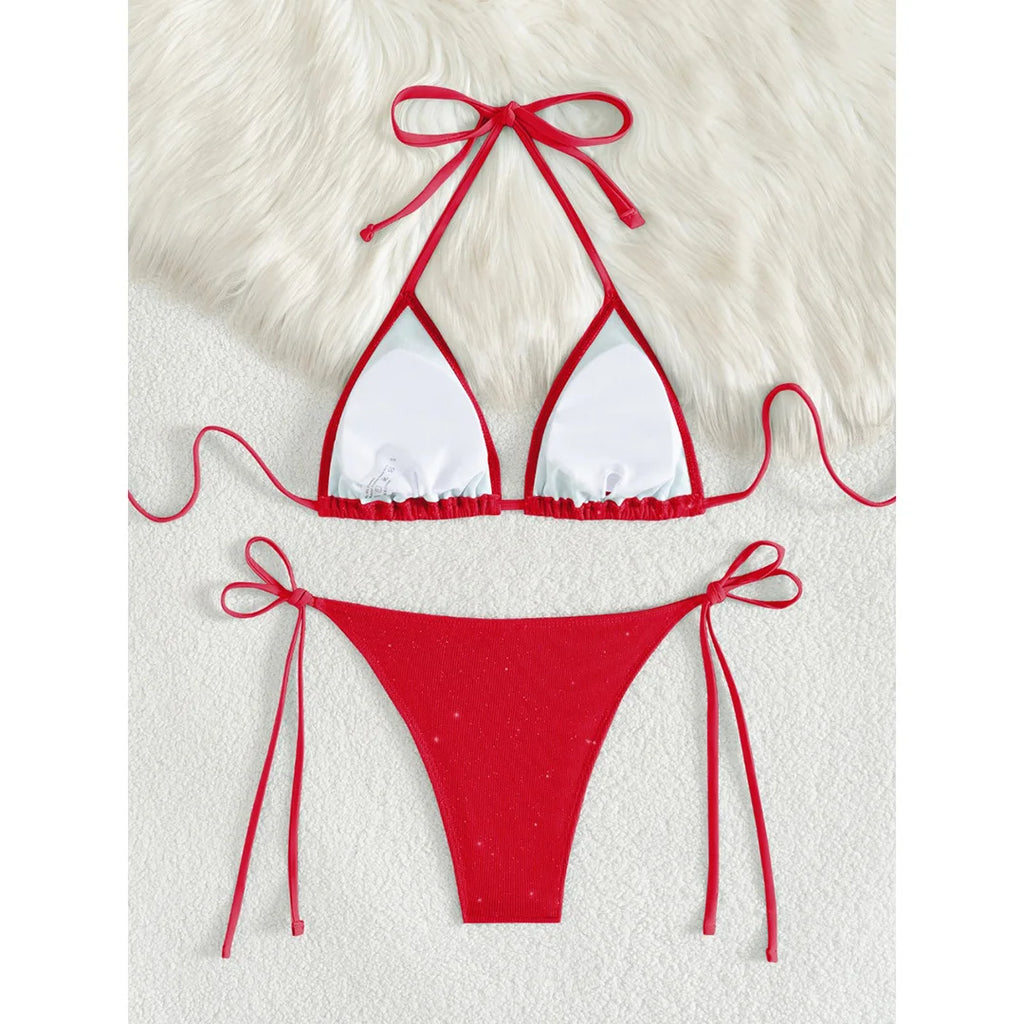 An elegant two-piece swimwear featuring a sparkling glitter finish, halter neckline, and high-leg cut, designed for a radiant and confident feminine beach look