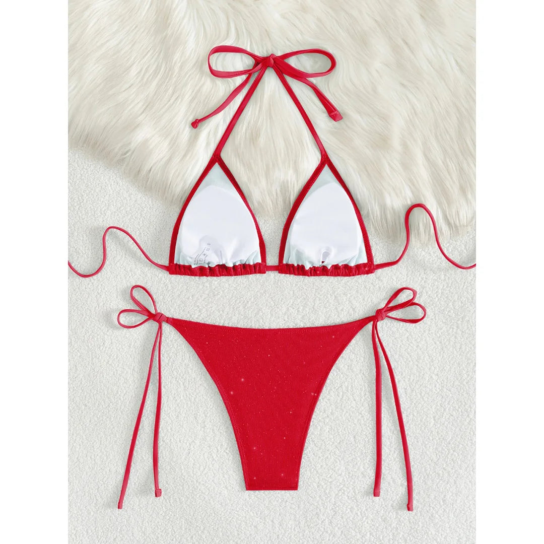An elegant two-piece swimwear featuring a sparkling glitter finish, halter neckline, and high-leg cut, designed for a radiant and confident feminine beach look