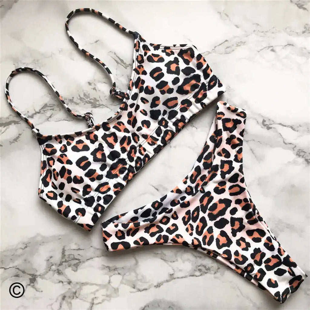 A refined leopard-print two-piece swimwear with a flattering Brazilian cut, designed to enhance feminine elegance and confident beach style