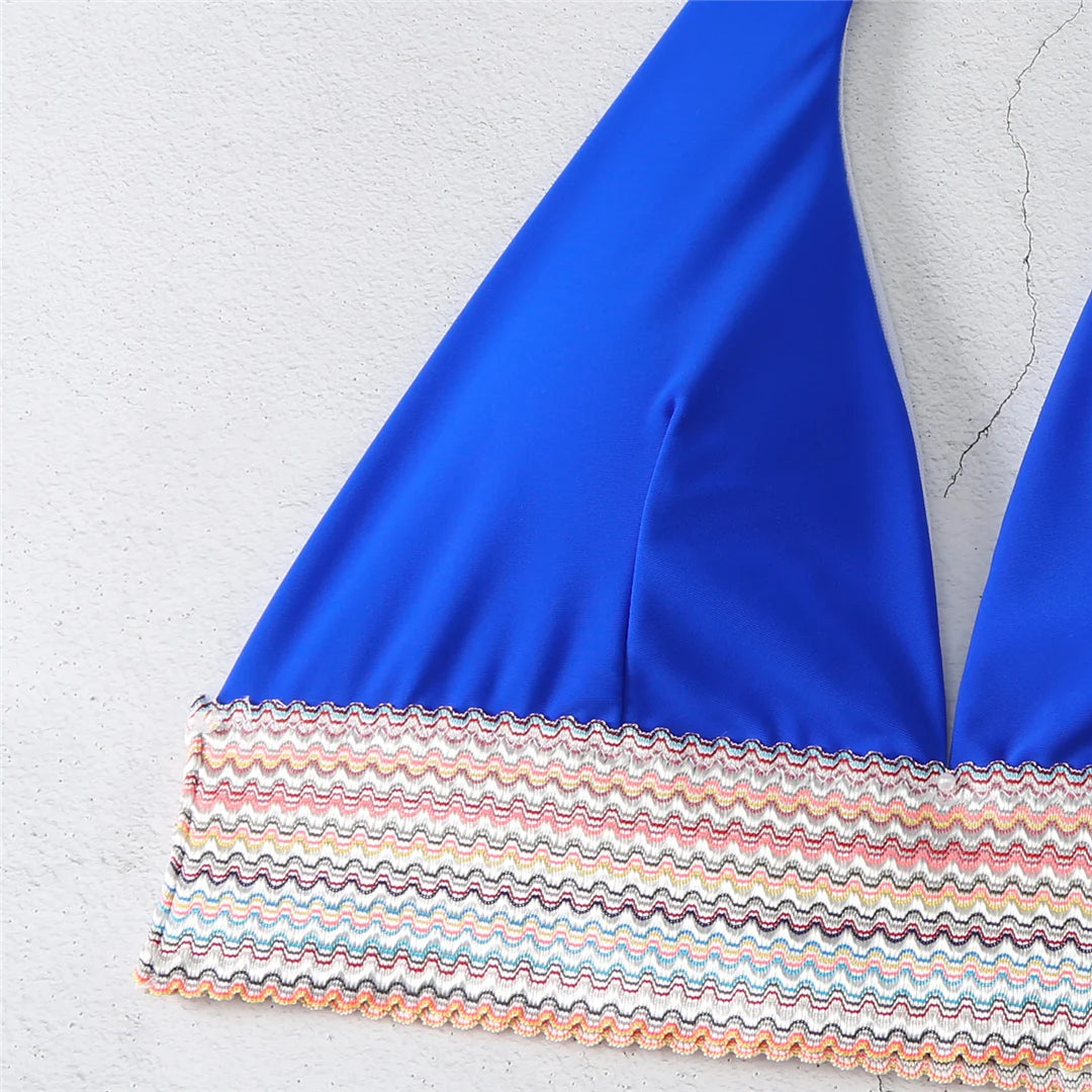 An elegant halter two-piece swimwear featuring refined color-splicing details and a flattering V-neck design, created for a modern, feminine beach style