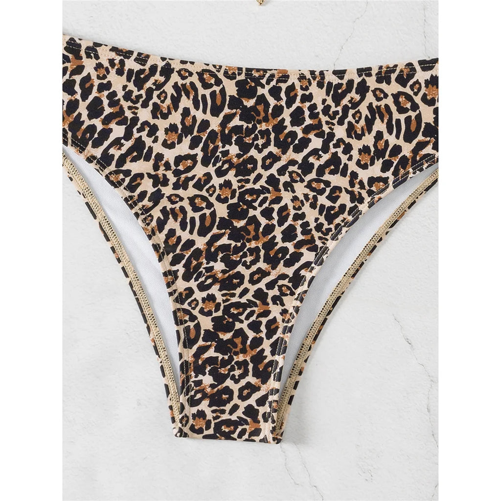 An elegant two-piece swimwear featuring a chic leopard print, bandeau top, and high-leg cut, designed for a feminine and confident beach look