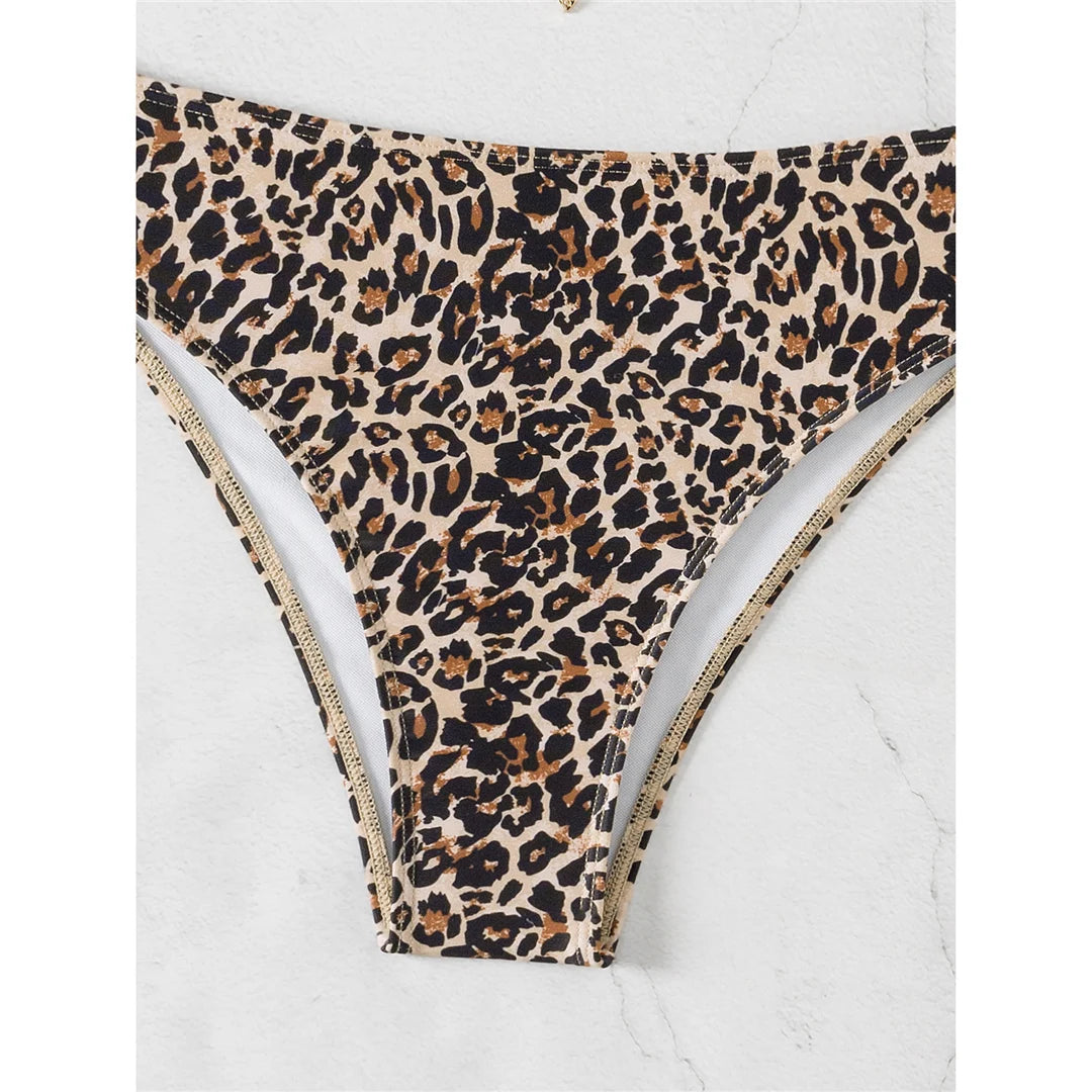 An elegant two-piece swimwear featuring a chic leopard print, bandeau top, and high-leg cut, designed for a feminine and confident beach look