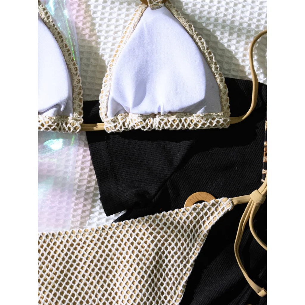 An elegant halter two-piece swimwear featuring sheer mesh and strappy detailing with a flattering high-cut leg, designed for a bold yet feminine beach look