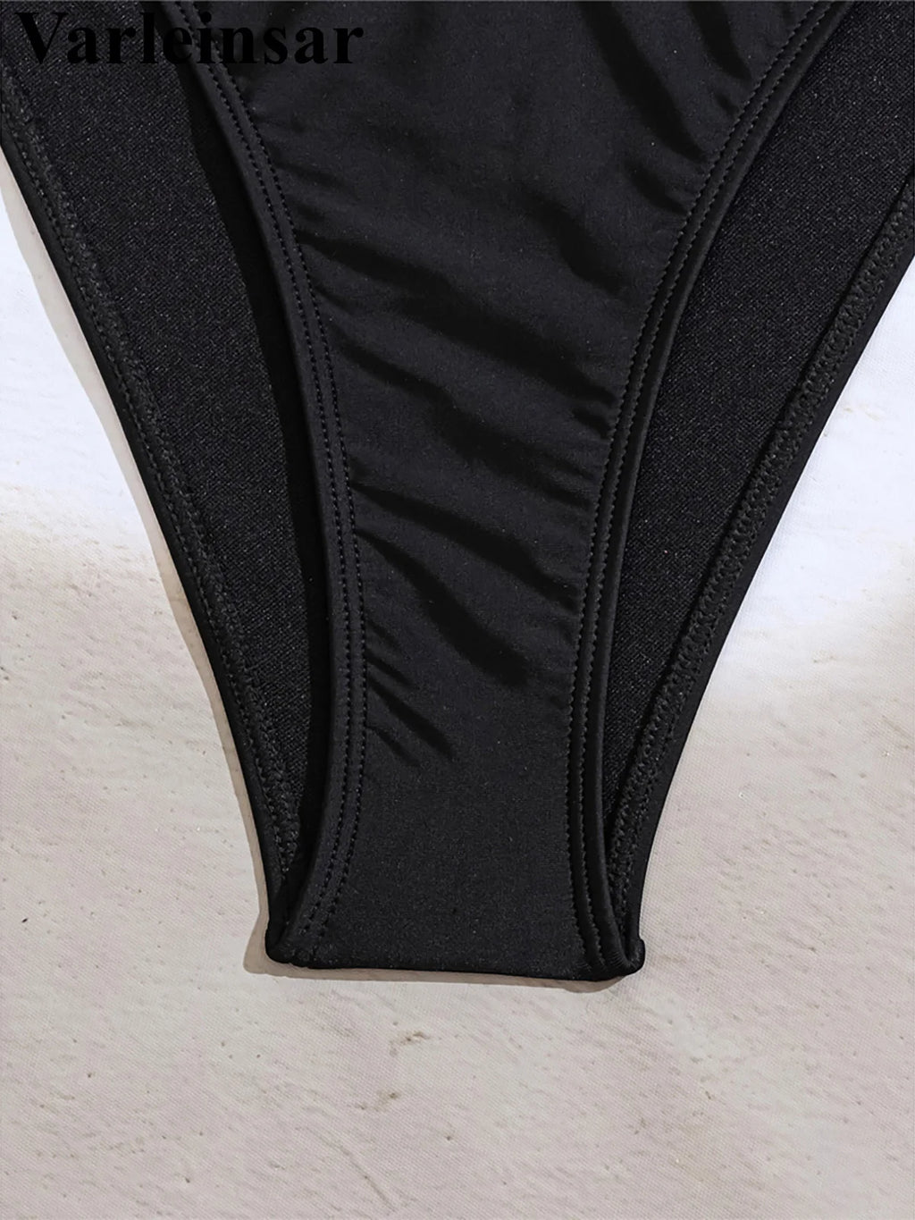 An elegant halter two-piece swimwear adorned with sparkling diamond star accents, designed for a feminine and radiant beach look with refined glamour