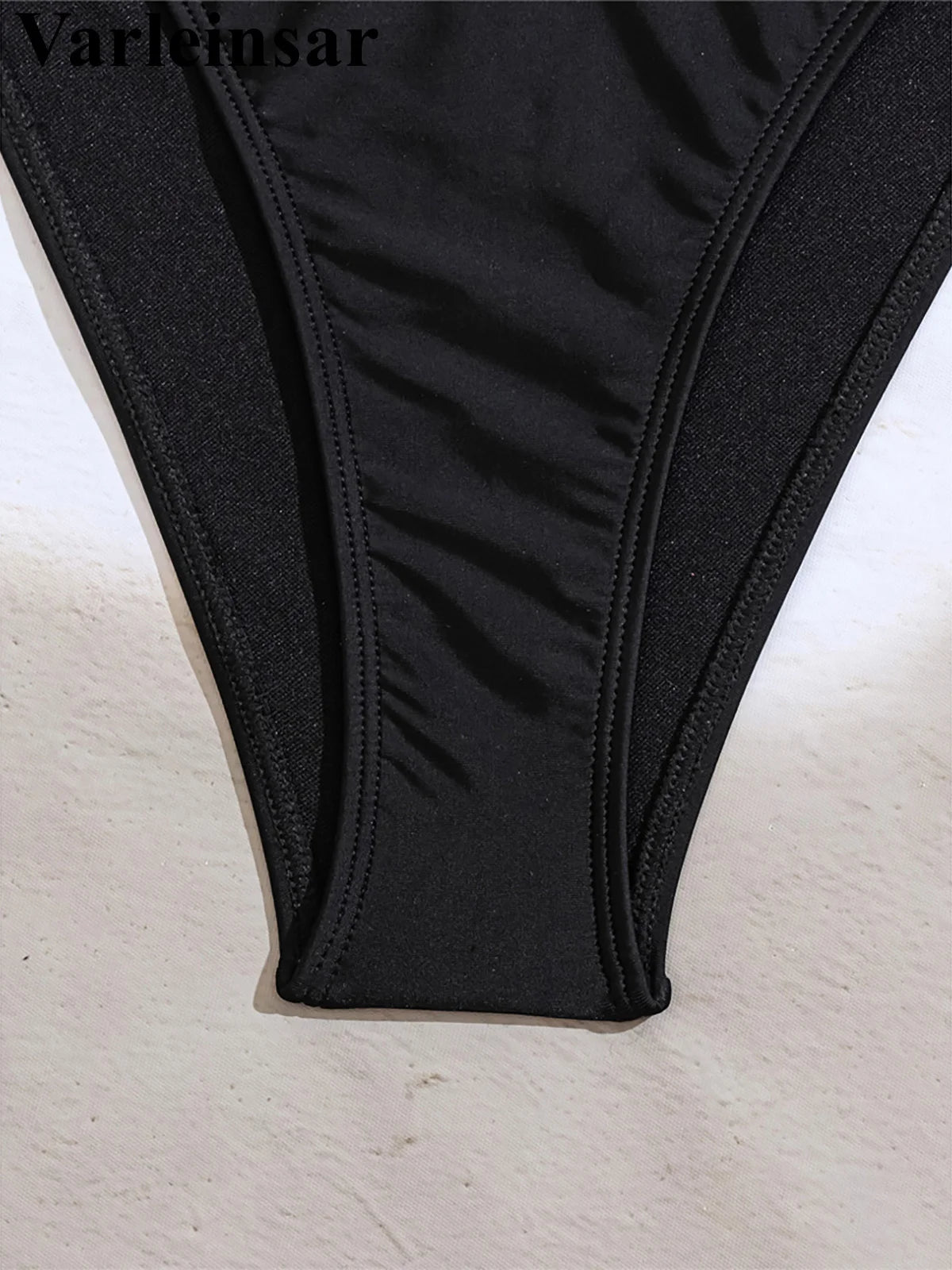 An elegant halter two-piece swimwear adorned with sparkling diamond star accents, designed for a feminine and radiant beach look with refined glamour