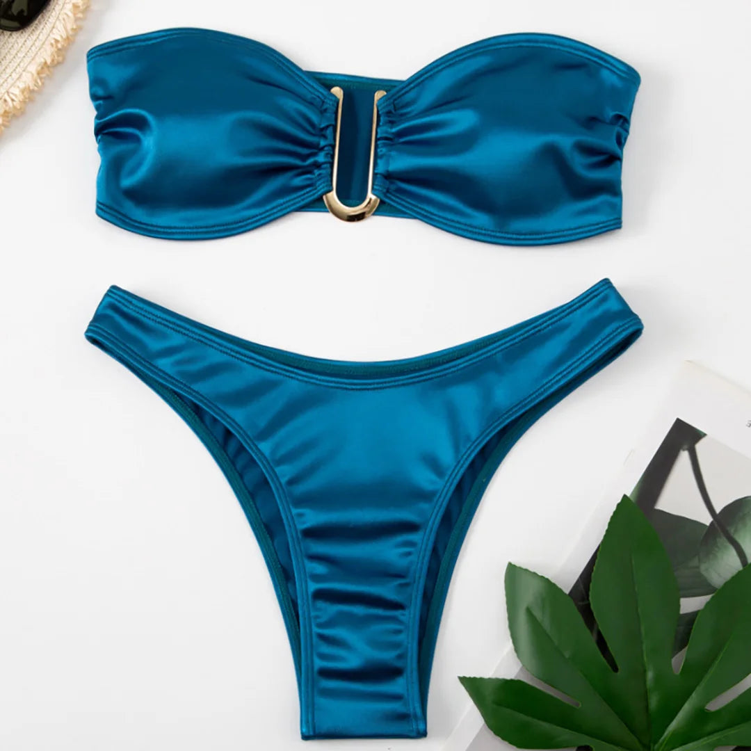 An elegant two-piece swimwear featuring a sleek strapless bandeau top with padded support, designed for a feminine, minimal, and confident beach look