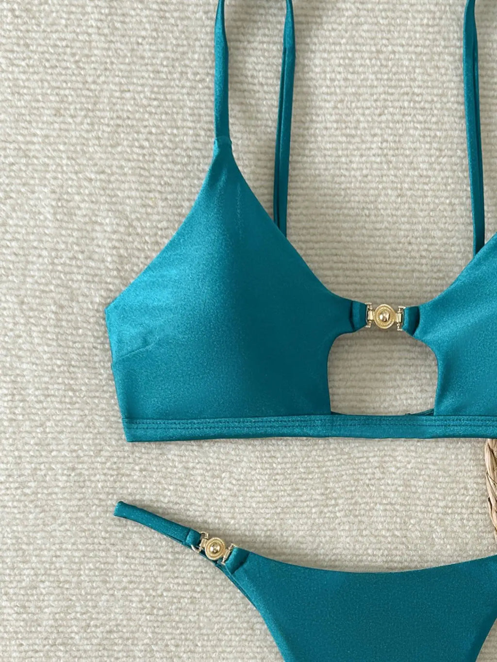 A sleek, shiny two-piece swimwear featuring a flattering push-up triangle top and Brazilian cheeky cut, designed for a bold yet elegant beach and vacation look