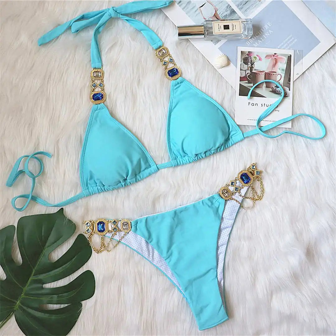 An elegant two-piece swimwear embellished with luxurious rhinestone detailing, designed to deliver a radiant and feminine beach look with a touch of refined glamour