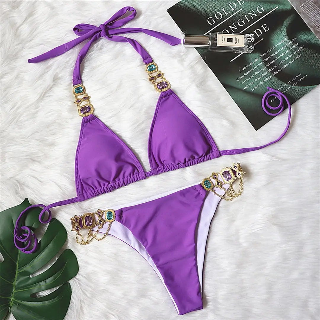 An elegant two-piece swimwear embellished with luxurious rhinestone detailing, designed to deliver a radiant and feminine beach look with a touch of refined glamour
