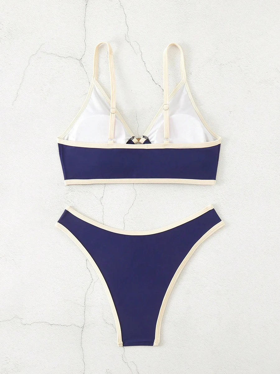 A bold yet refined Brazilian two-piece swimwear featuring a halter top and thong cut, designed for a confident, feminine beach statement