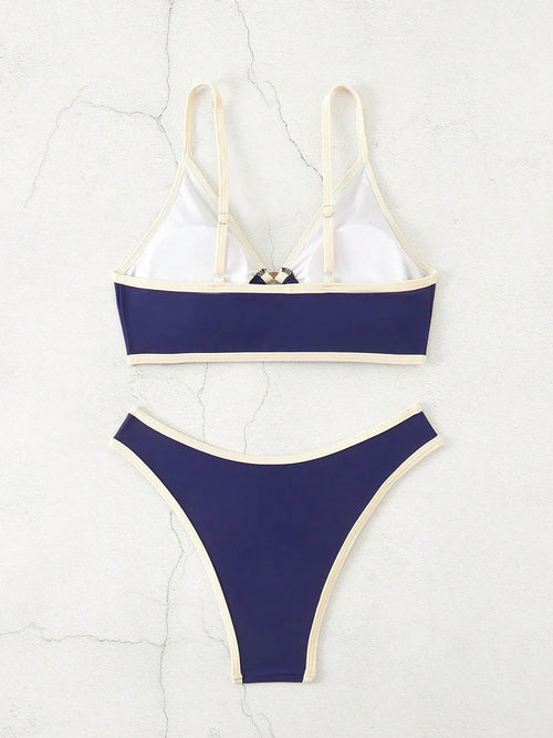 A bold yet refined Brazilian two-piece swimwear featuring a halter top and thong cut, designed for a confident, feminine beach statement