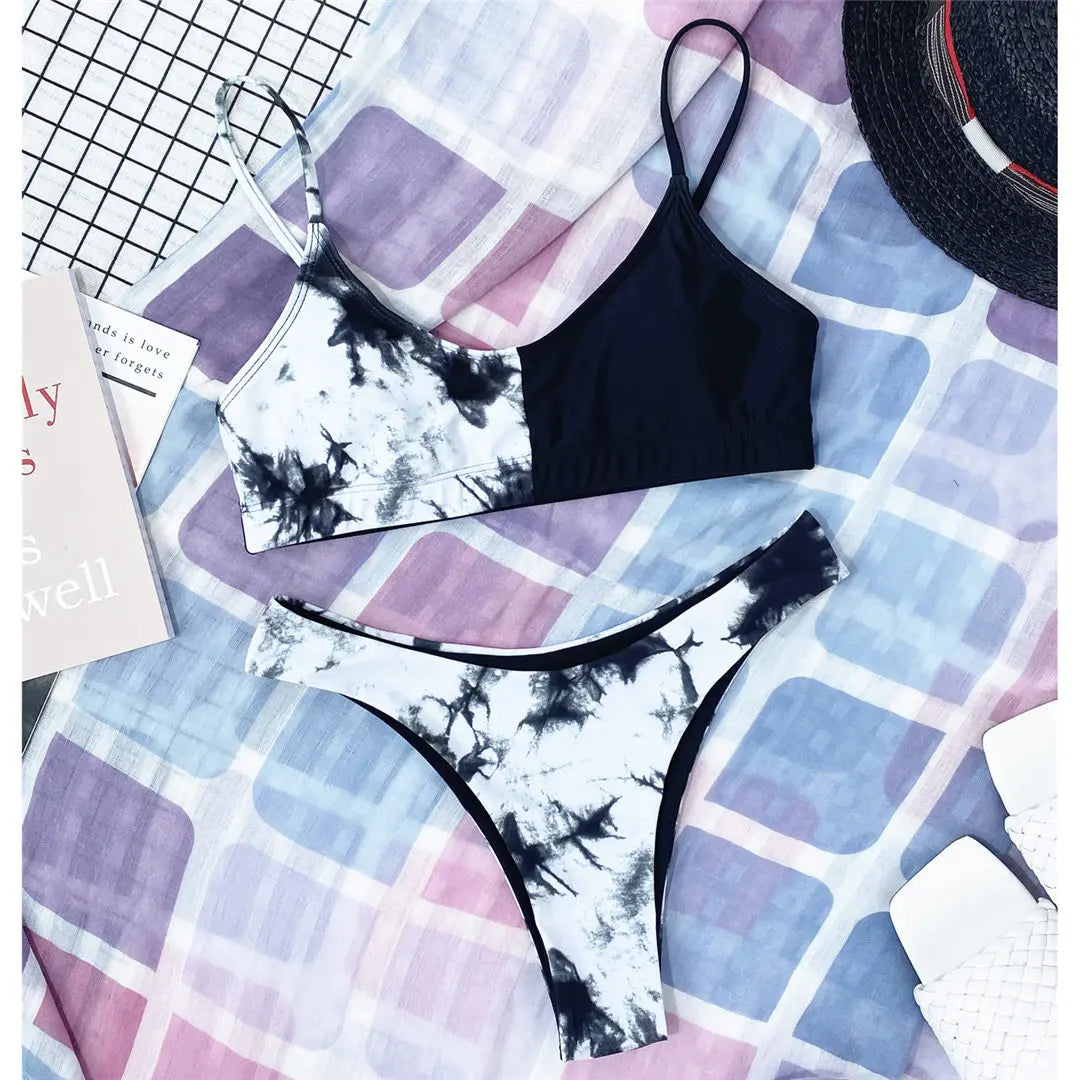 A refined leopard-print two-piece swimwear with a flattering Brazilian cut, designed to enhance feminine elegance and confident beach style