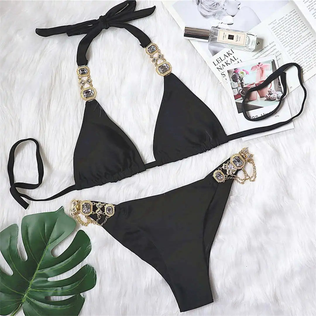 An elegant two-piece swimwear embellished with luxurious rhinestone detailing, designed to deliver a radiant and feminine beach look with a touch of refined glamour