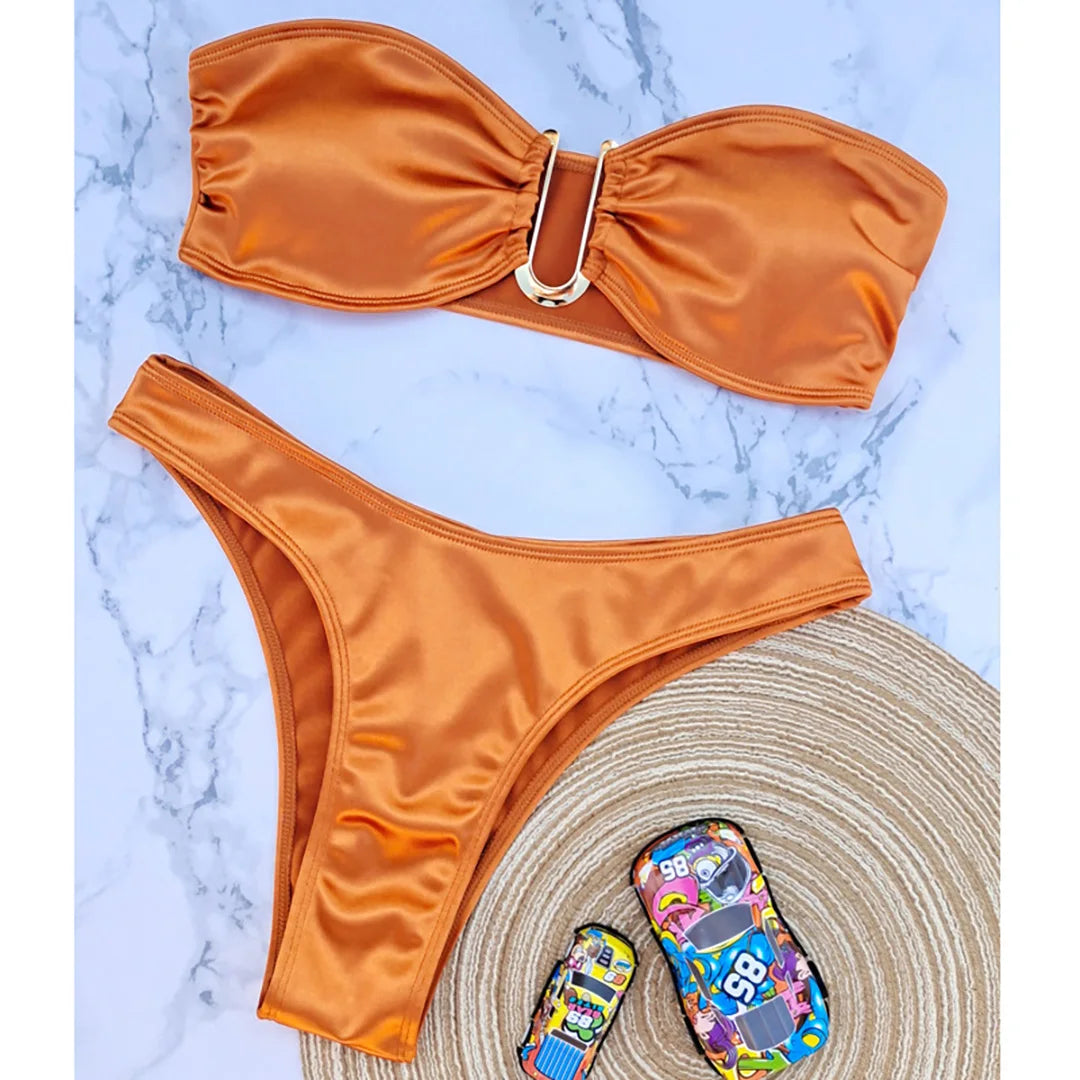 An elegant two-piece swimwear featuring a sleek strapless bandeau top with padded support, designed for a feminine, minimal, and confident beach look