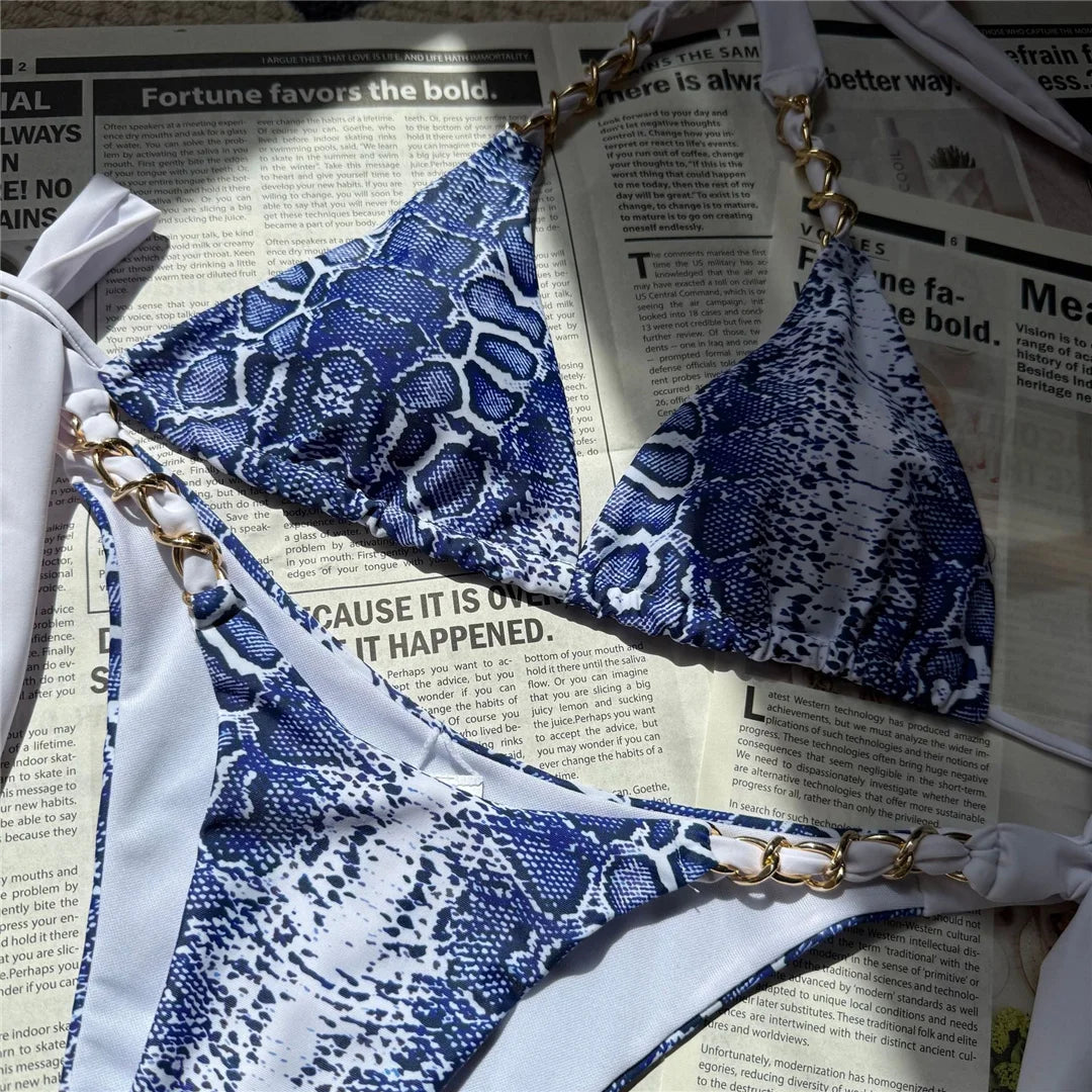 An elegant halter two-piece swimwear with a refined snakeskin-inspired print and strappy detailing, designed for a bold yet feminine beach look