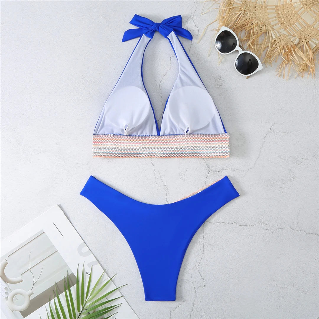 An elegant halter two-piece swimwear featuring refined color-splicing details and a flattering V-neck design, created for a modern, feminine beach style