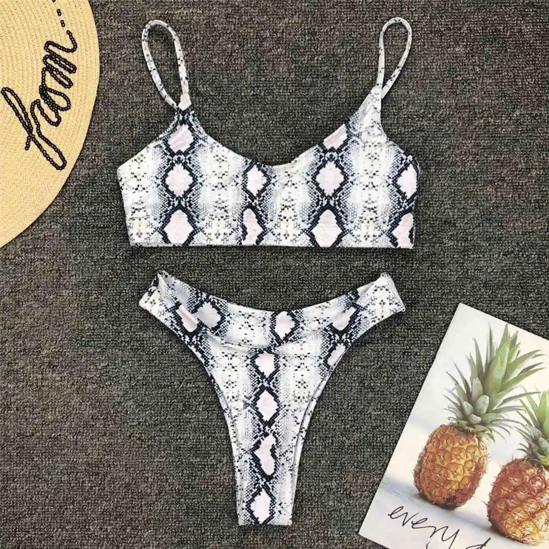 A refined leopard-print two-piece swimwear with a flattering Brazilian cut, designed to enhance feminine elegance and confident beach style