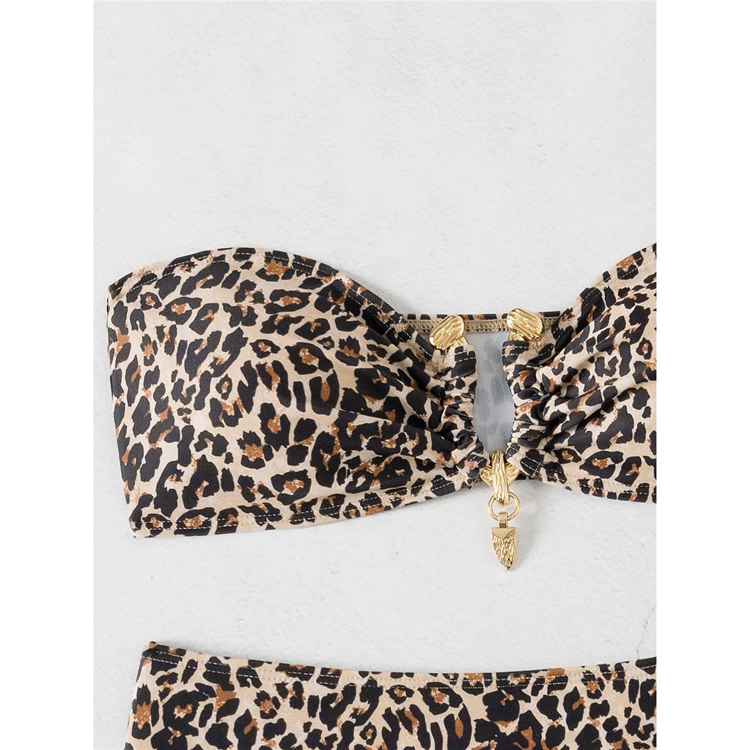 An elegant two-piece swimwear featuring a chic leopard print, bandeau top, and high-leg cut, designed for a feminine and confident beach look