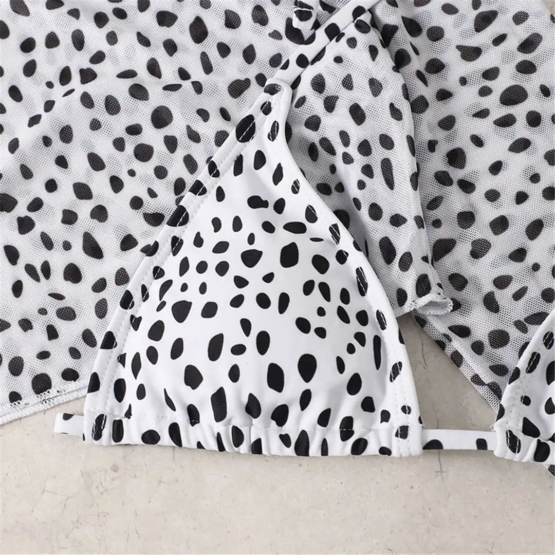 An elegant three-piece swimwear featuring a bold leopard print, long-sleeve top, and matching bikini set, designed for a feminine yet confident and stylish beach look