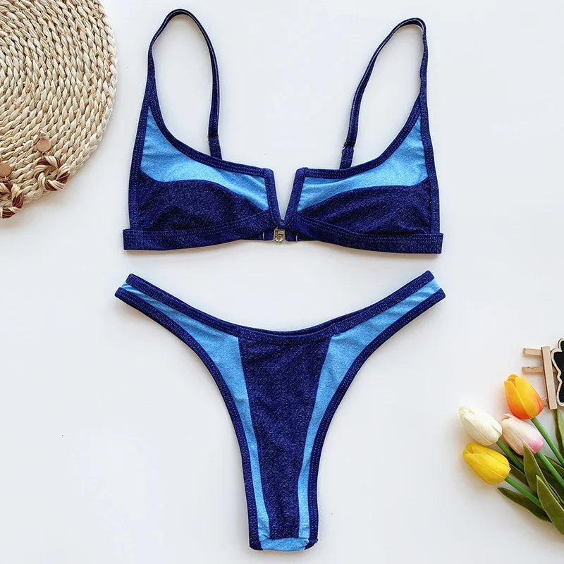 A sleek two-piece swimwear featuring a flattering V-shaped thong bottom and push-up top, designed for a bold yet elegant feminine beach look