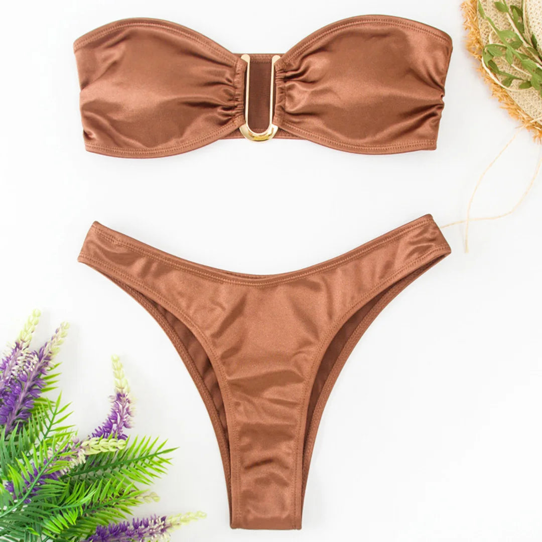 An elegant two-piece swimwear featuring a sleek strapless bandeau top with padded support, designed for a feminine, minimal, and confident beach look