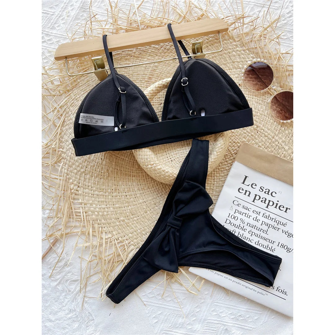 An elegant two-piece swimwear featuring a delicate bow detail, padded top, and flattering high-cut thong design, created for a bold yet feminine beach statement