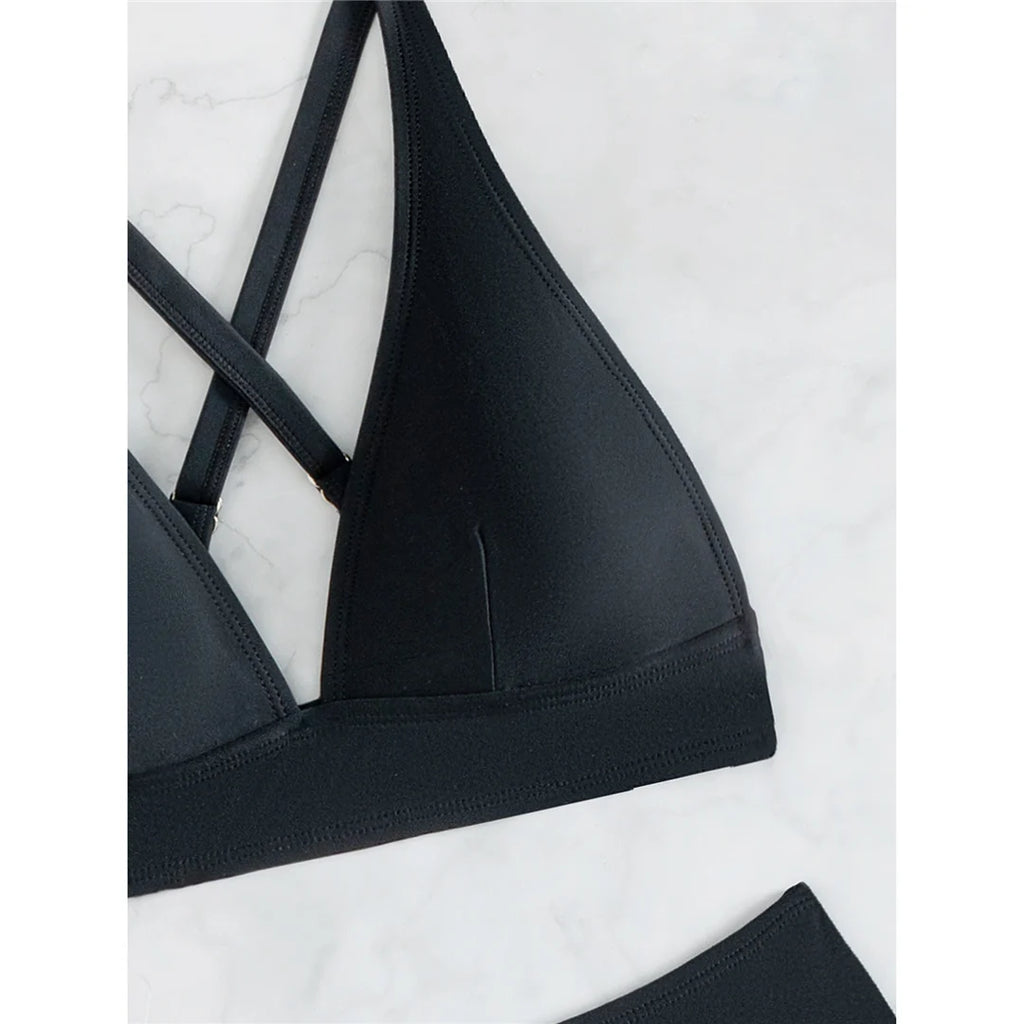 A sleek cross-back two-piece swimwear with a minimal thong cut, designed for a bold yet elegant feminine beach look