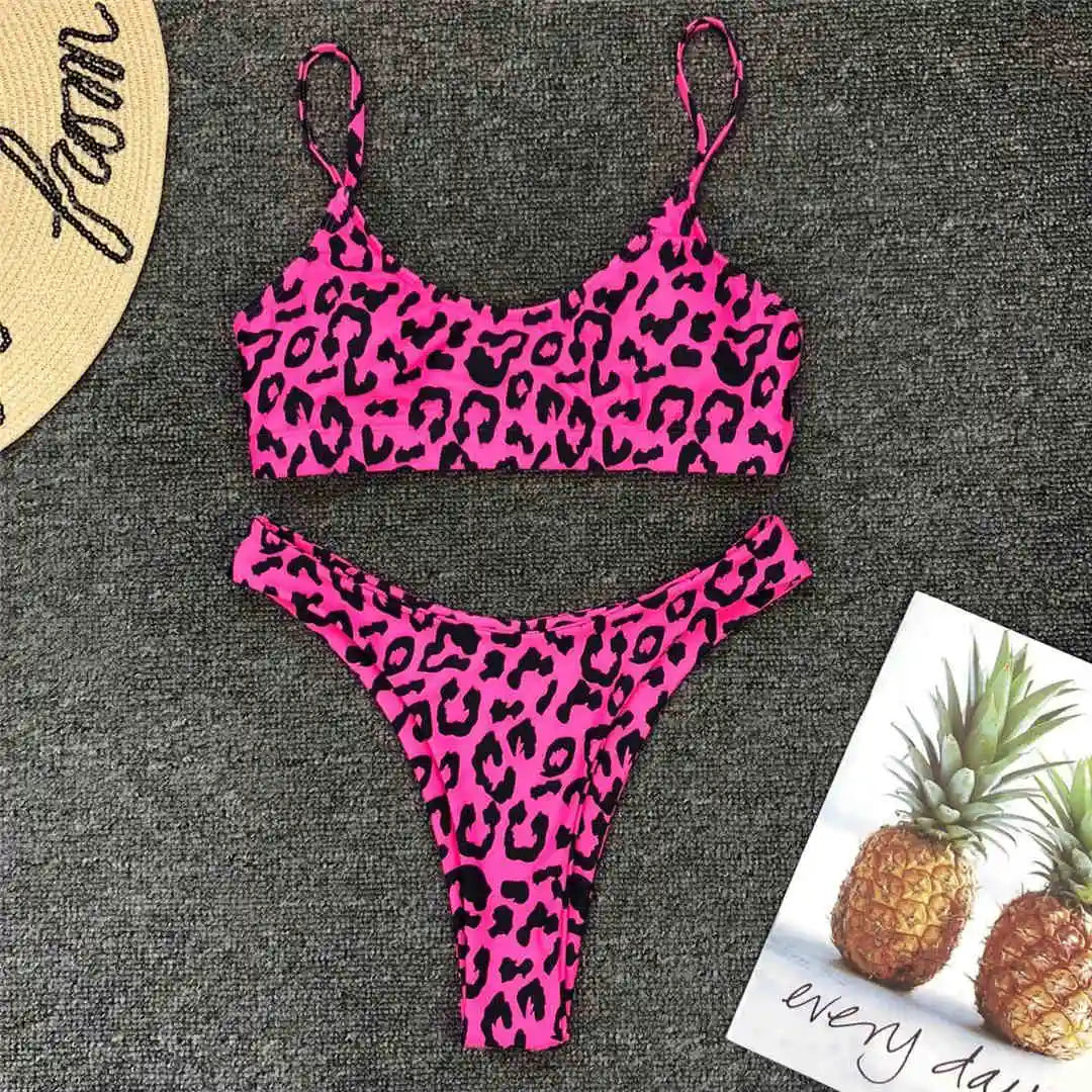 A refined leopard-print two-piece swimwear with a flattering Brazilian cut, designed to enhance feminine elegance and confident beach style