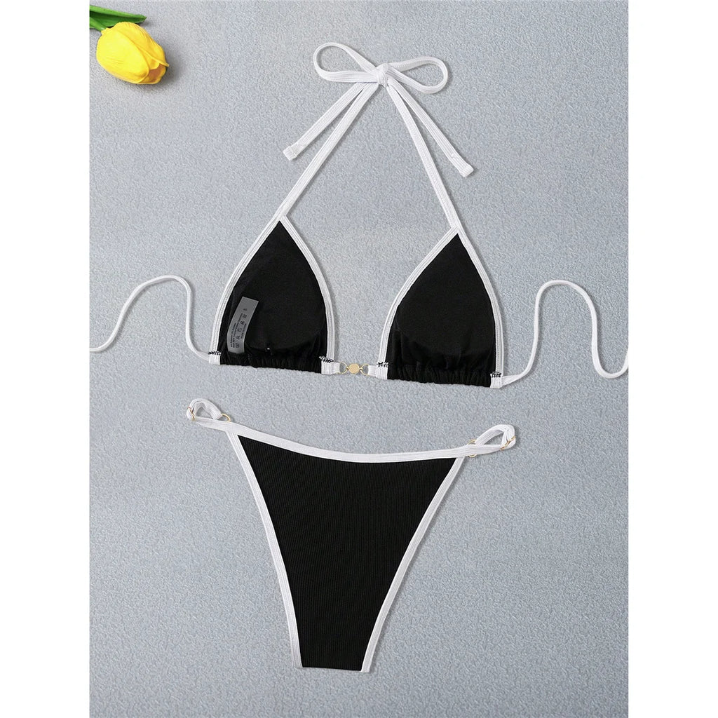 An elegant two-piece swimwear featuring refined pearl accents, a ribbed texture, and a flattering high-cut silhouette, designed for a timeless and feminine beach look