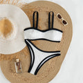 A refined two-piece swimwear featuring a padded top and flattering Brazilian high-cut leg, designed for an elegant and confident feminine beach look