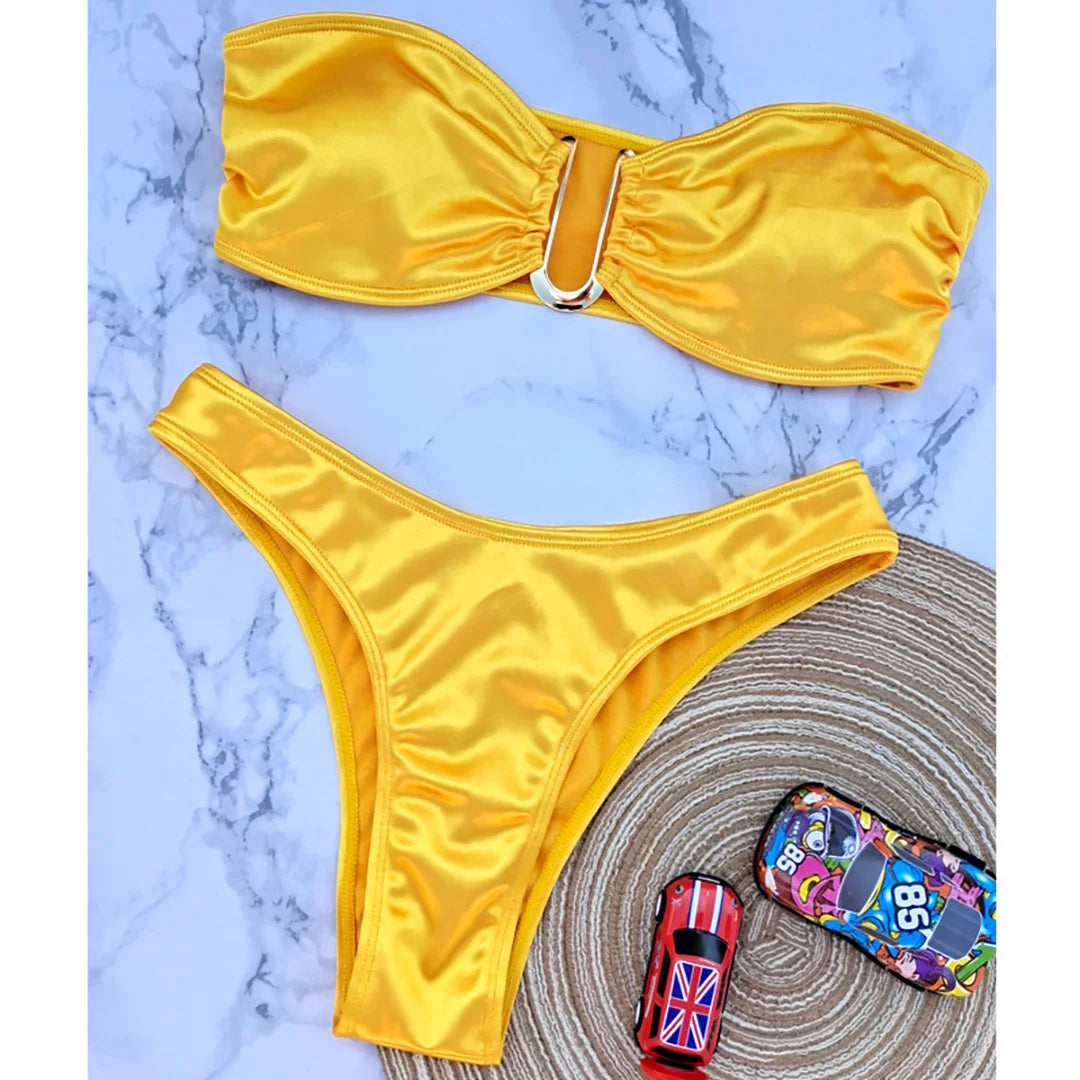 An elegant two-piece swimwear featuring a sleek strapless bandeau top with padded support, designed for a feminine, minimal, and confident beach look