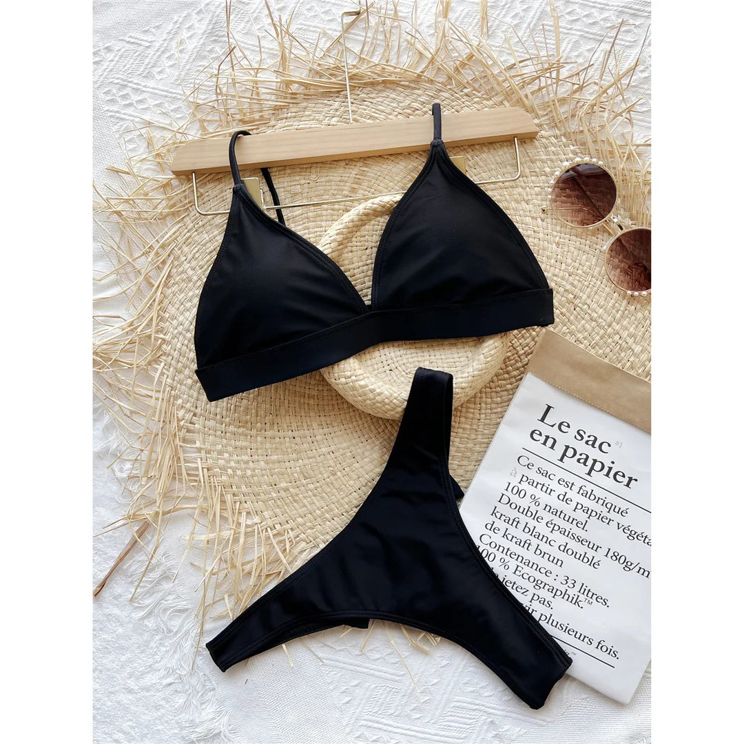 An elegant two-piece swimwear featuring a delicate bow detail, padded top, and flattering high-cut thong design, created for a bold yet feminine beach statement