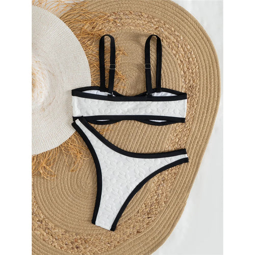 A refined two-piece swimwear featuring a padded top and flattering Brazilian high-cut leg, designed for an elegant and confident feminine beach look