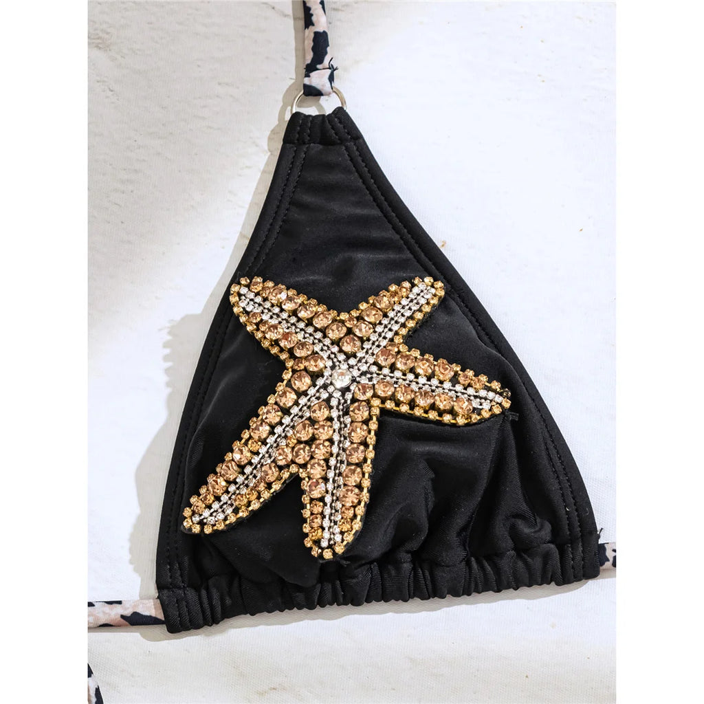 An elegant halter two-piece swimwear adorned with sparkling diamond star accents, designed for a feminine and radiant beach look with refined glamour