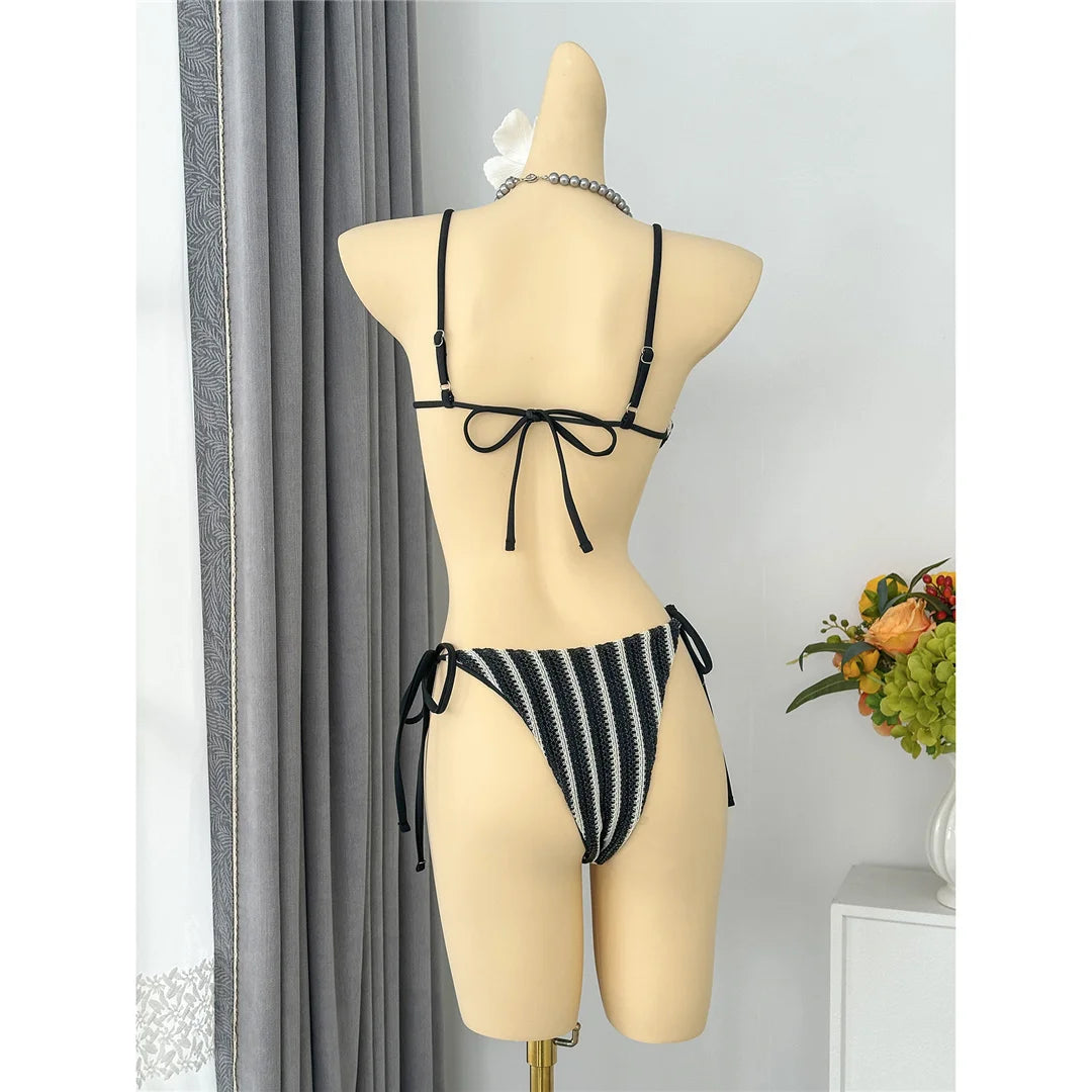 An elegant two-piece swimwear featuring a modern striped design, padded top, and flattering high-cut leg, created for a clean, feminine, and confident beach style