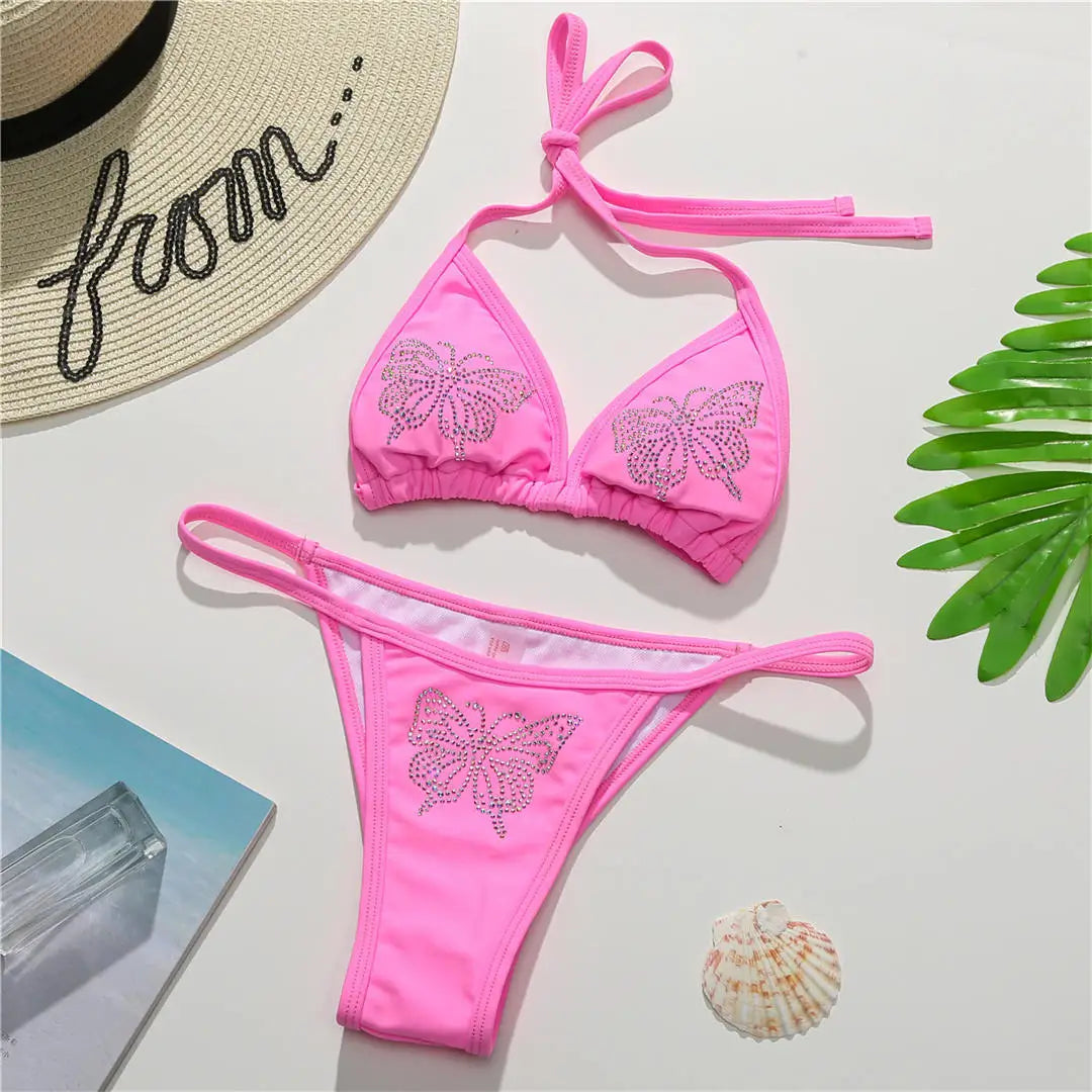 An elegant halter two-piece swimwear adorned with sparkling butterfly rhinestone details, designed to bring a feminine and radiant touch to your beach style