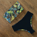 An elegant reversible two-piece swimwear featuring a bandeau top with cross-halter detail and a high-waisted bottom, designed for versatile, feminine summer style