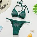 An elegant halter two-piece swimwear adorned with sparkling butterfly rhinestone details, designed to bring a feminine and radiant touch to your beach style