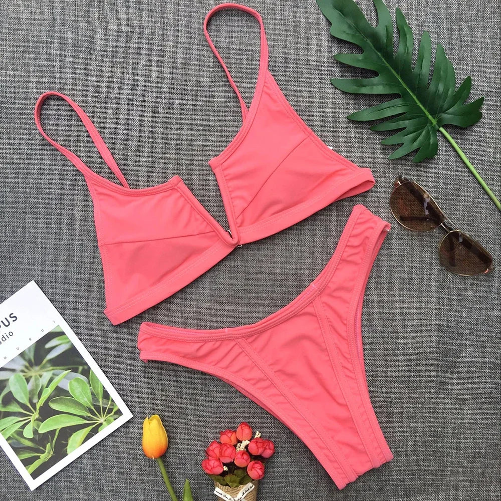 A sleek two-piece swimwear featuring a flattering V-shaped thong bottom and push-up top, designed for a bold yet elegant feminine beach look
