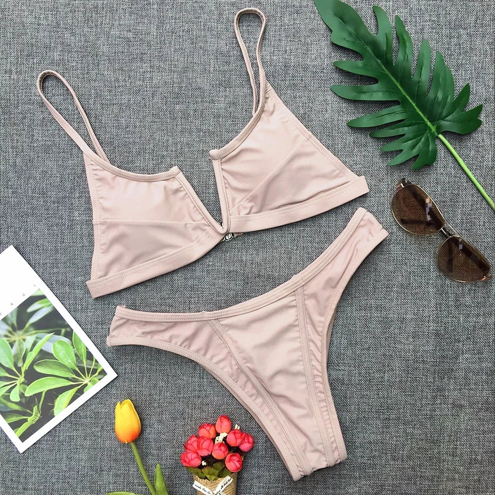 A sleek two-piece swimwear featuring a flattering V-shaped thong bottom and push-up top, designed for a bold yet elegant feminine beach look