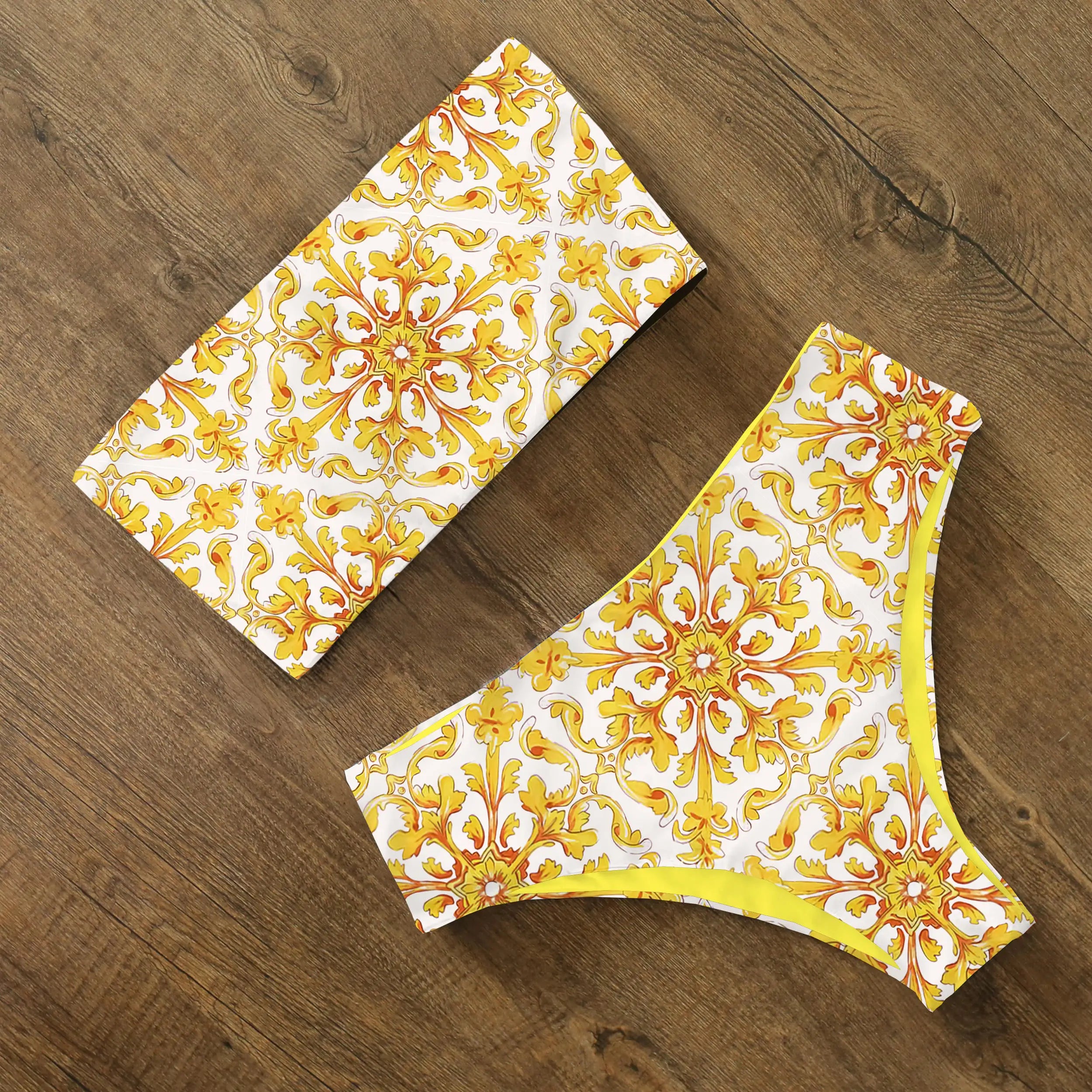 An elegant reversible two-piece swimwear featuring a bandeau top with cross-halter detail and a high-waisted bottom, designed for versatile, feminine summer style
