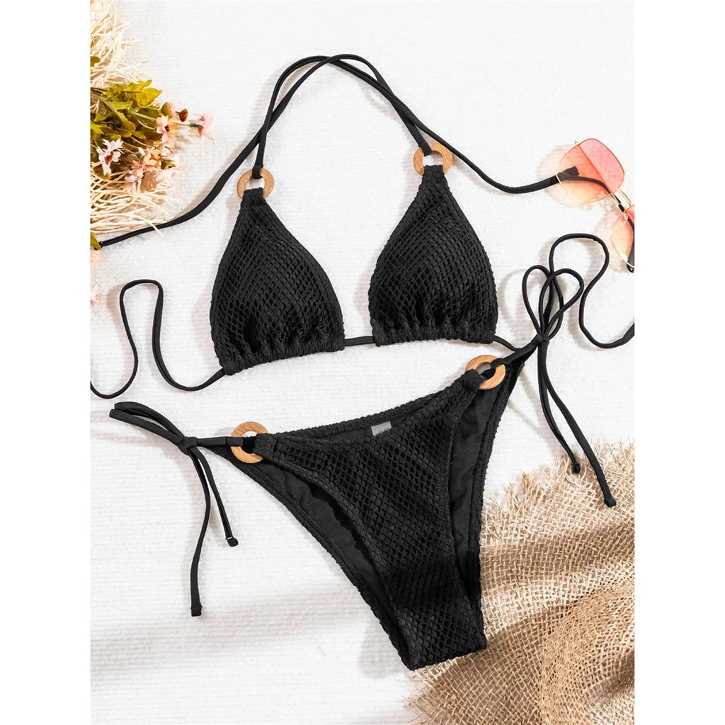 An elegant halter two-piece swimwear featuring sheer mesh and strappy detailing with a flattering high-cut leg, designed for a bold yet feminine beach look