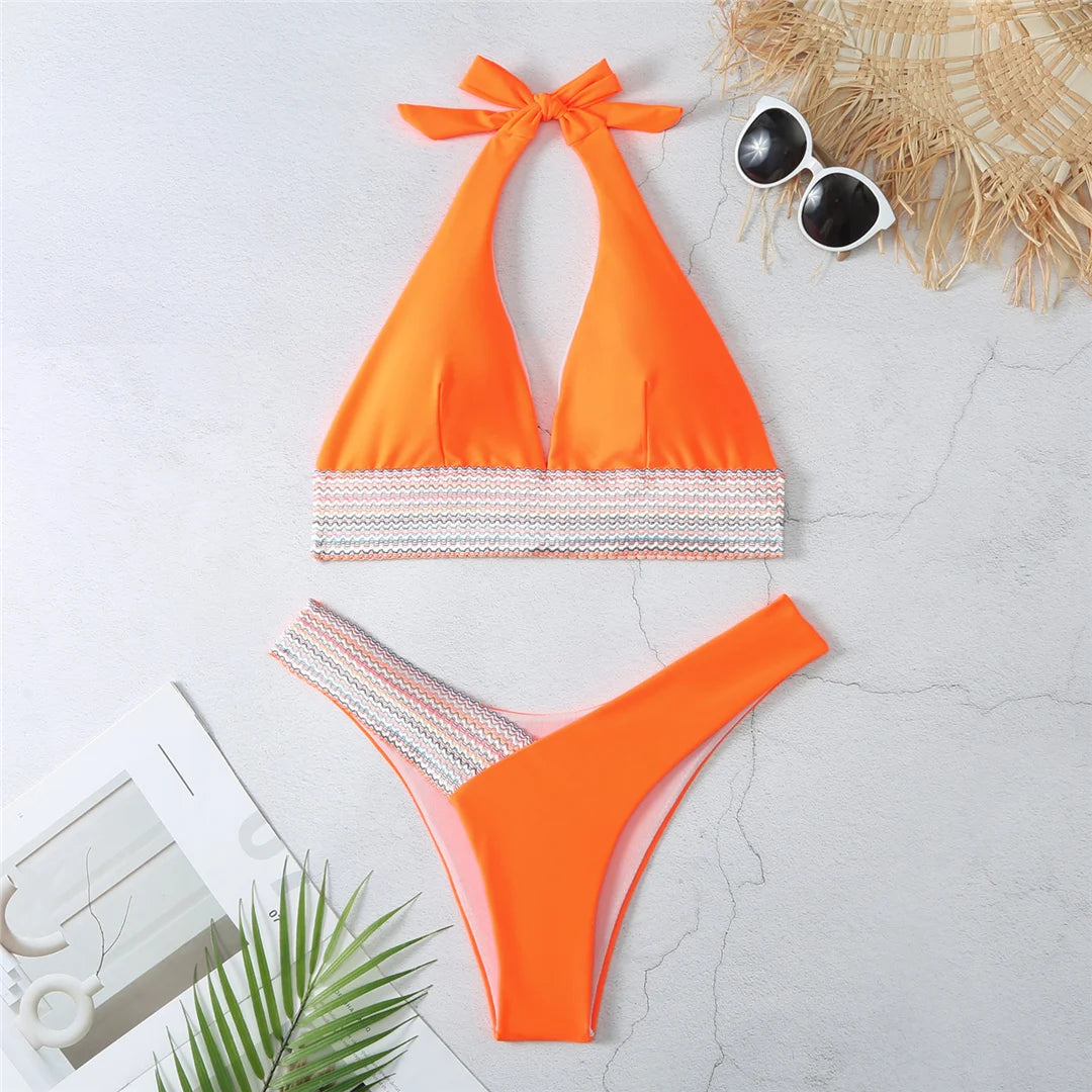 An elegant halter two-piece swimwear featuring refined color-splicing details and a flattering V-neck design, created for a modern, feminine beach style