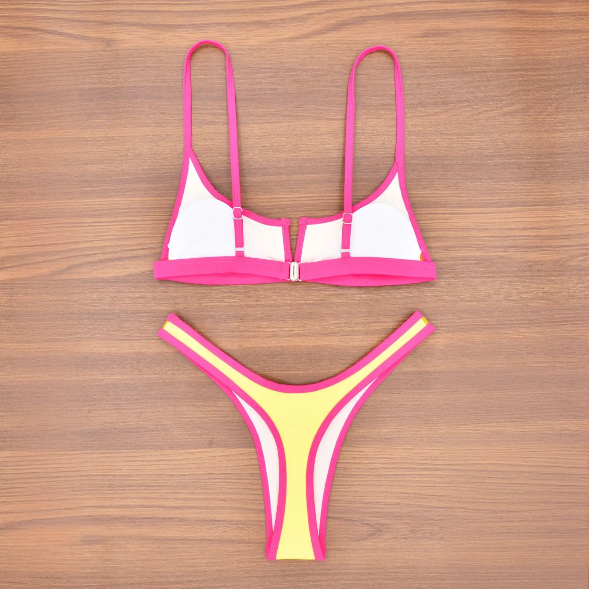 A sleek two-piece swimwear featuring a flattering V-shaped thong bottom and push-up top, designed for a bold yet elegant feminine beach look
