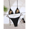 An elegant halter two-piece swimwear adorned with sparkling diamond star accents, designed for a feminine and radiant beach look with refined glamour
