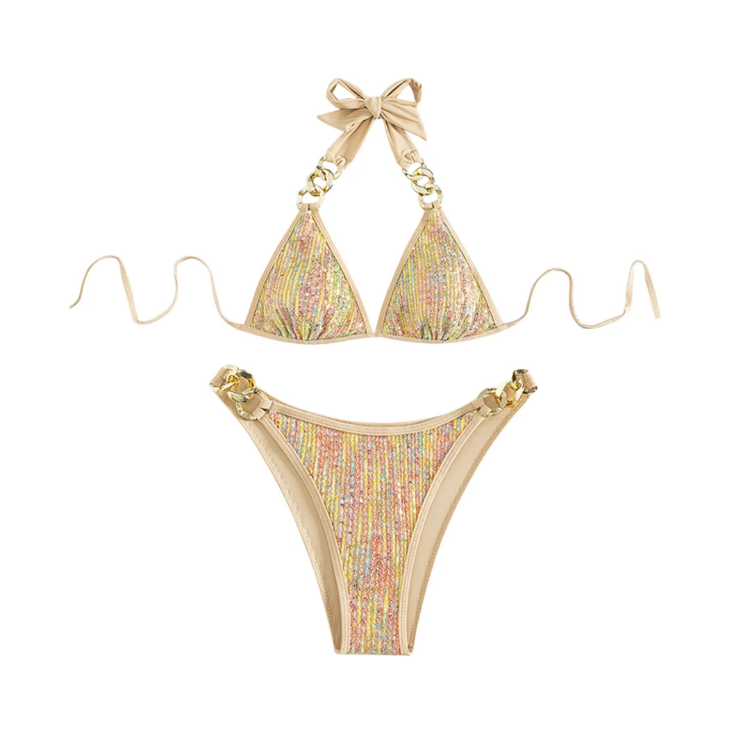 An elegant halter two-piece swimwear with shimmering sequin detail and refined metal ring accents, designed for a bold yet feminine beach statement