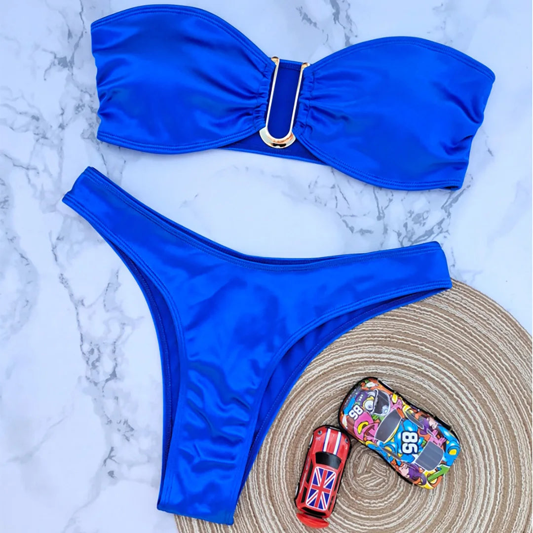 An elegant two-piece swimwear featuring a sleek strapless bandeau top with padded support, designed for a feminine, minimal, and confident beach look