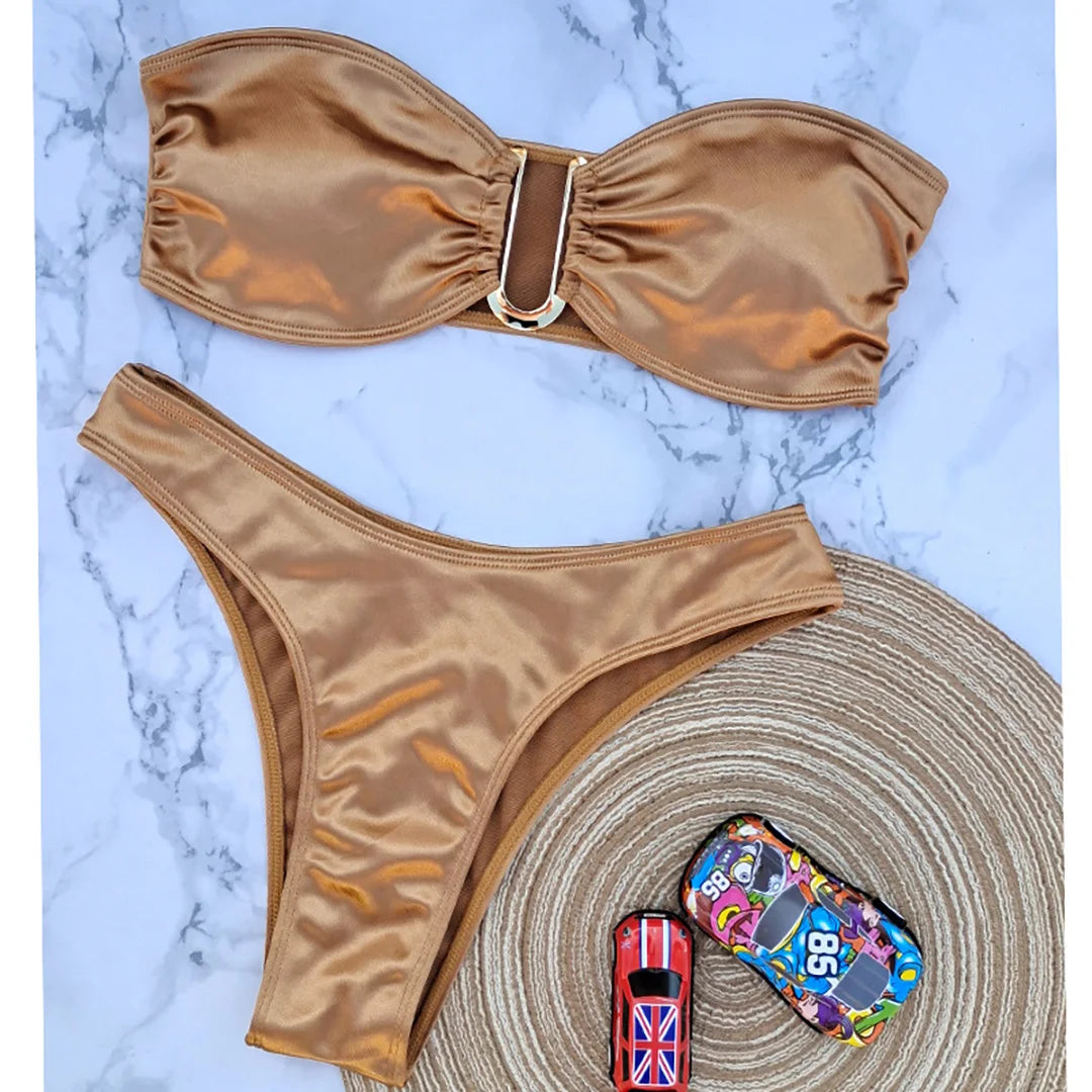 An elegant two-piece swimwear featuring a sleek strapless bandeau top with padded support, designed for a feminine, minimal, and confident beach look