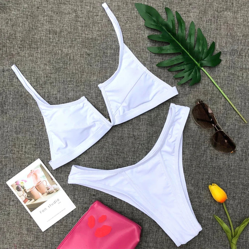 A sleek two-piece swimwear featuring a flattering V-shaped thong bottom and push-up top, designed for a bold yet elegant feminine beach look