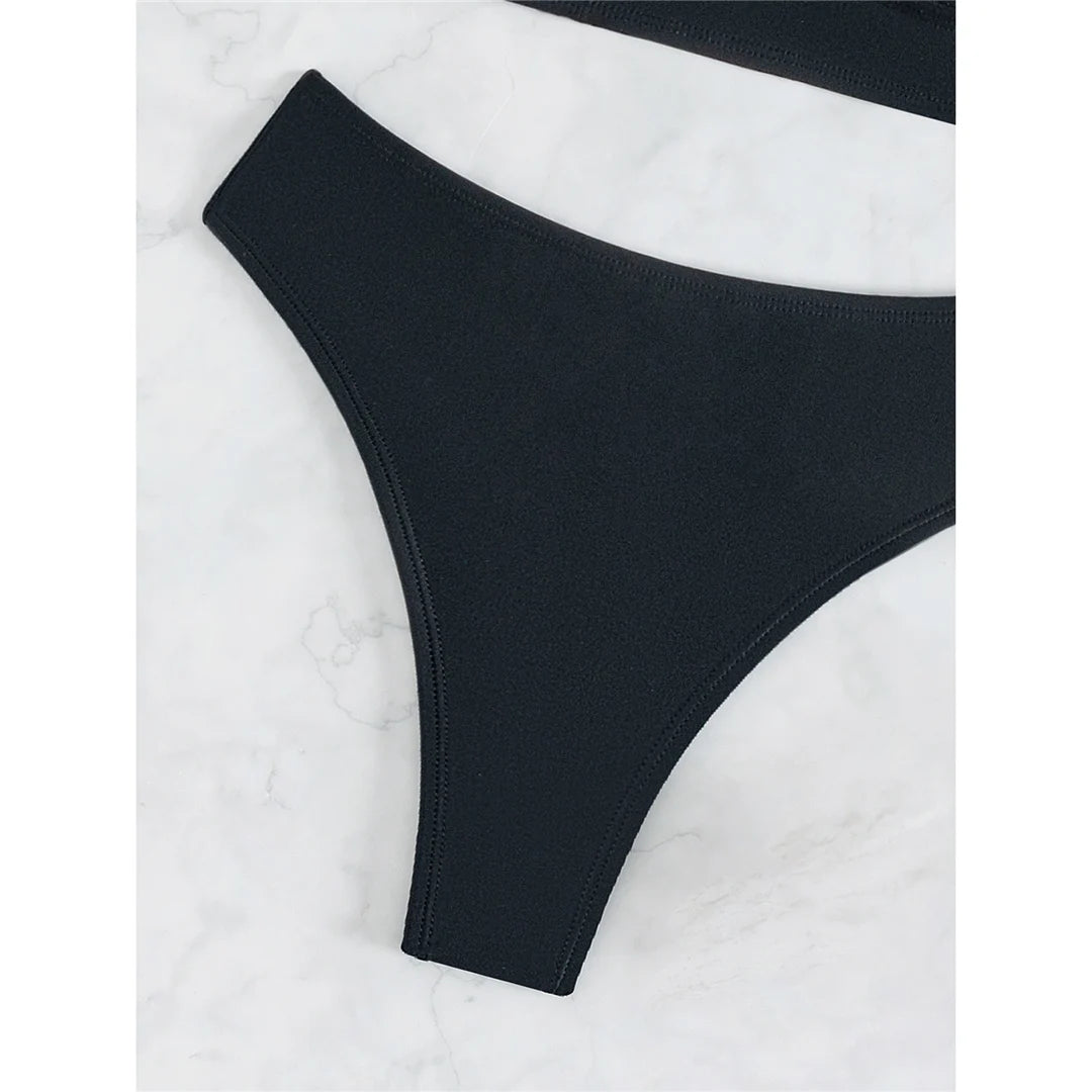 A sleek cross-back two-piece swimwear with a minimal thong cut, designed for a bold yet elegant feminine beach look